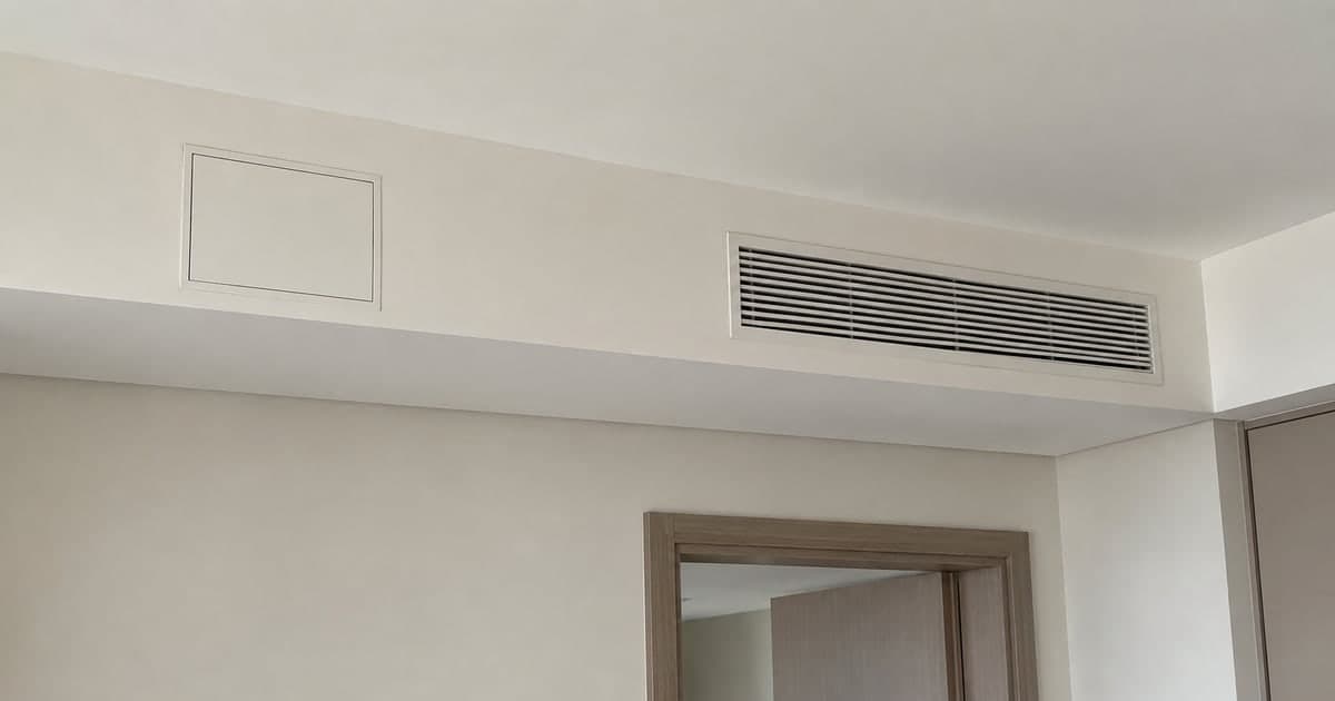 Closed ceiling service hatch beside an AC grille