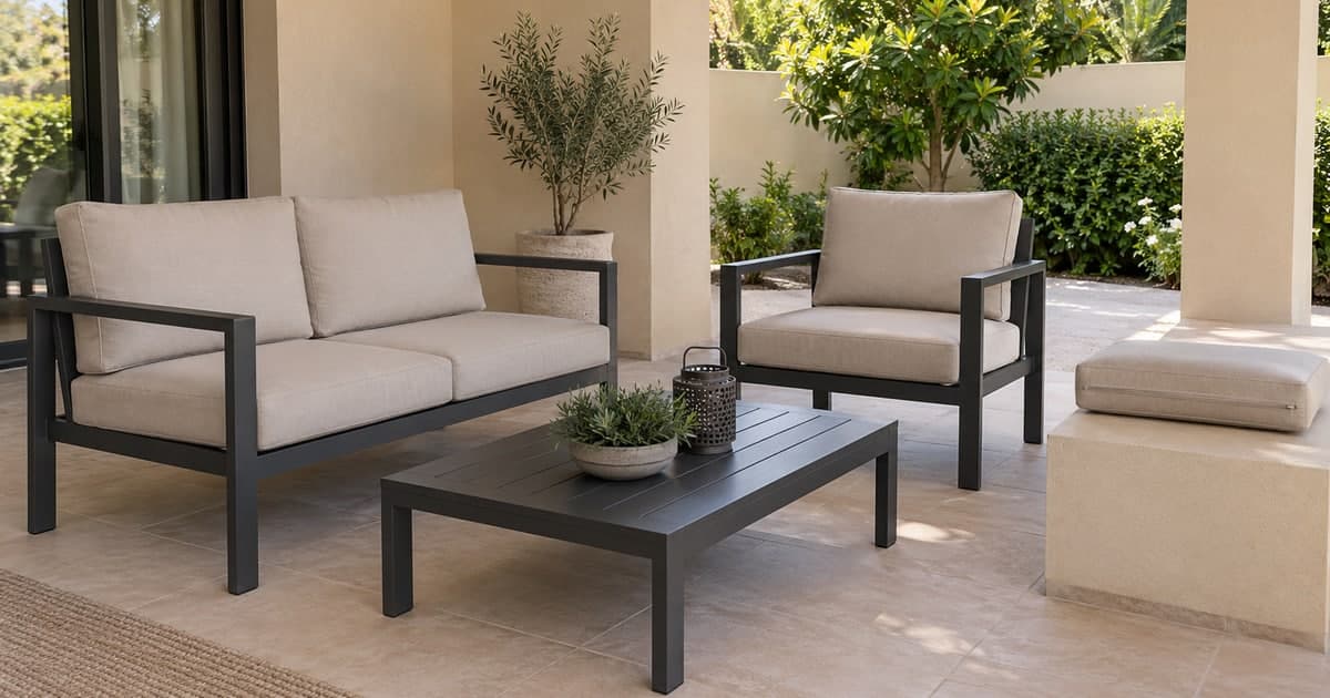 Properly fitted neutral outdoor sofa and chair cushions on a covered villa terrace